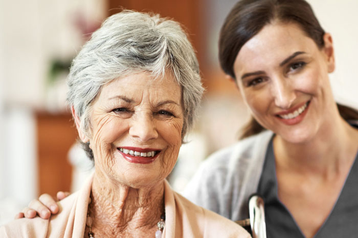 senior woman smiling with care giver