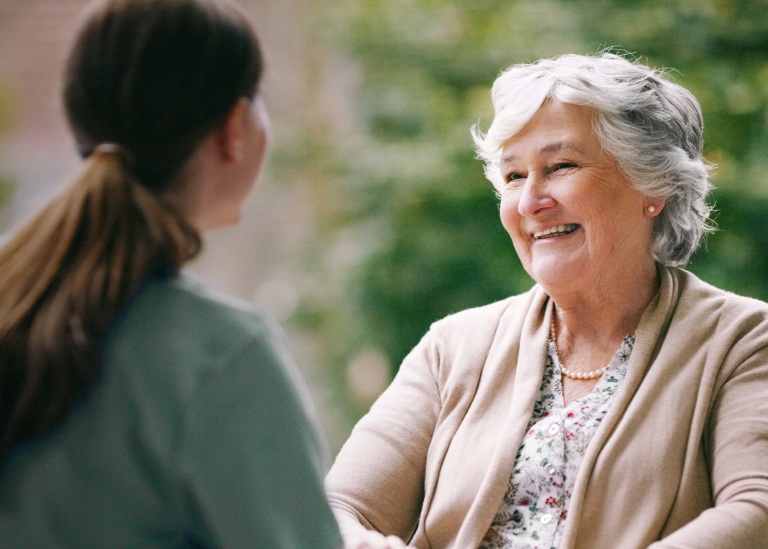senior woman smiling with care giver
