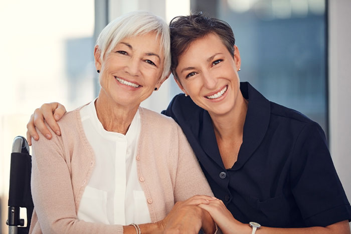 senior woman smiling with care giver