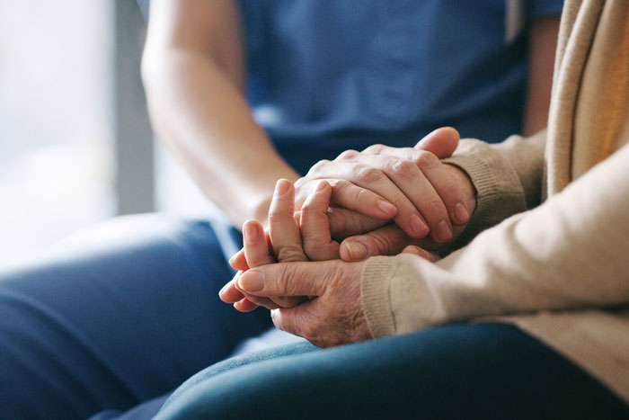 holding hands with senior