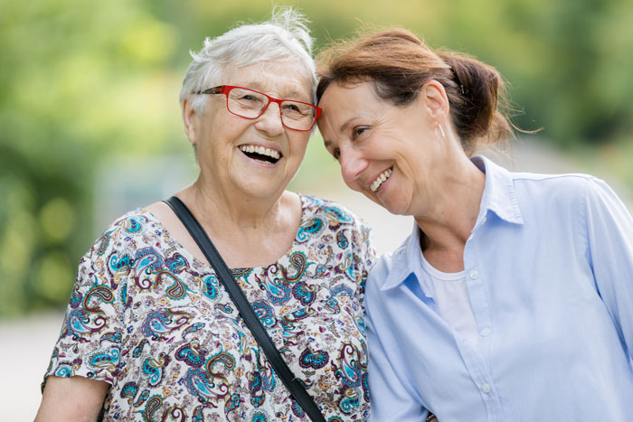 senior woman smiling with care giver
